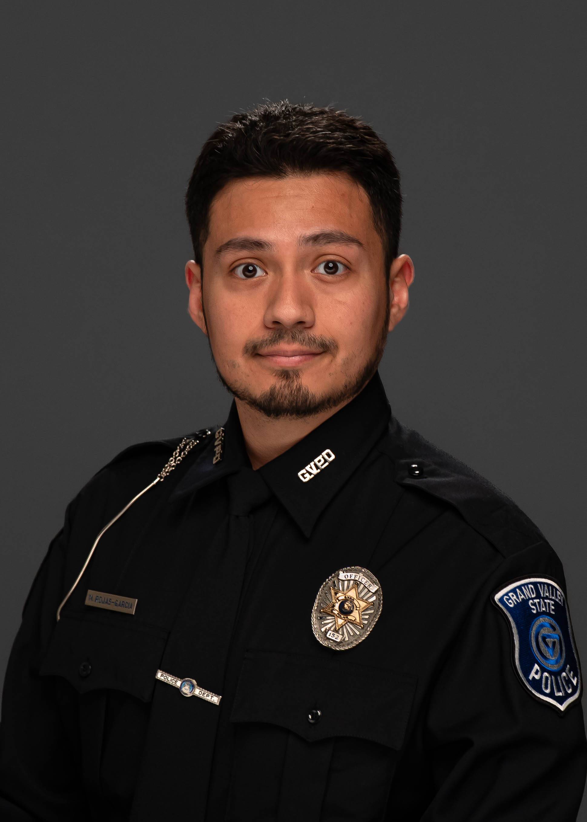 Headshot / portrait of Hispanic male police officer wearing a dress uniform
